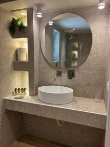 a bathroom with a sink and a mirror at ΝΕΑΚΙΤΟΣ Luxury Apartments in Nikiti +48 photos