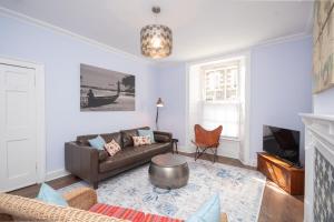 a living room with a couch and a table at Banrigh House in Stirling