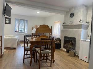 a living room with a table and a fireplace at La CASA de mis PADRES 2 in Arahuetes