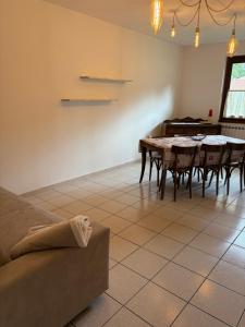 a living room with a table and chairs and a couch at Civico 16 in Asso
