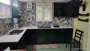 a kitchen with a sink and a counter top at Peaceful 1 BHK country home with open veranda & nature views in Thrissur, Kerala in Cheruthuruthi +20 photos