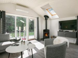 a living room with a couch and a fireplace at 5 star holiday home in Væggerløse in Bøtø By