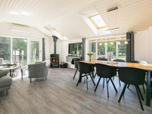 a living room with a dining room table and chairs at 5 star holiday home in Væggerløse in Bøtø By