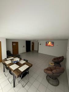 a living room with a table and some chairs at Cakir Home in Erftstadt