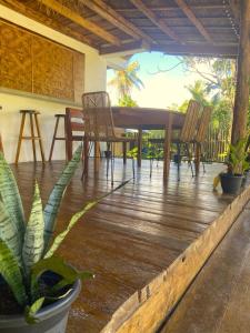 a wooden deck with chairs and a table at Spacious 2BR Villa with Garden in General Luna +35 photos