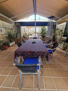 a table and chairs under an umbrella on a patio at La Casona in Redondela