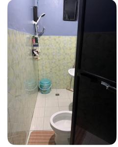 a small bathroom with a toilet and a sink at E&Z guest house in Sara