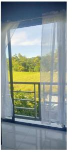 an open window with a view of a field at E&Z guest house in Sara +2 photos