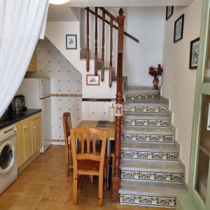 a kitchen with stairs and a table and chairs at Bungalow Pitxintxo Gran Playa in Santa Pola