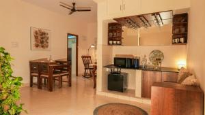 a kitchen and dining room with a table and a dining room at Luho White House in Bangalore