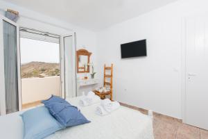 a living room with a couch and a large window at Villa Lena in Stelida