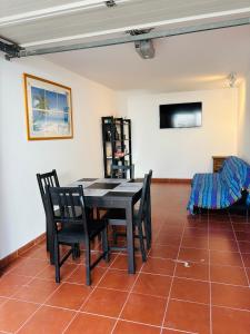 a dining room with a black table and chairs at Atlantic Breeze House in Corralejo
