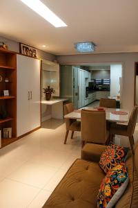 a kitchen and living room with a couch and a table at Village Prime Umarizal in Belém +5 photos