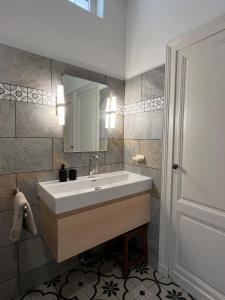 a bathroom with a sink and a mirror at Les Mimosas in Arcachon +40 photos