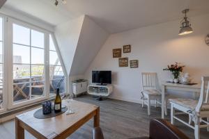 Televiisor ja/või meelelahutuskeskus majutusasutuses Dünenrand