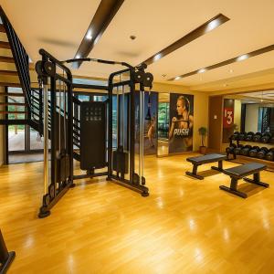 a gym with treadmills and weights in a room at Luxury 1-Bedroom Apartment Across Okada Manila in Manila