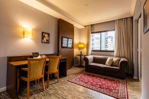 a living room with a couch and a table at #TW1301 | ZER01 Suítes |Flat em Hotel Vila Olimpia in Sao Paulo
