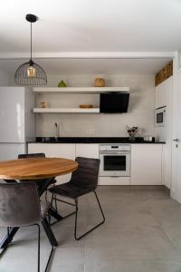a kitchen with a wooden table and chairs at Apt The V home in Puerto del Carmen