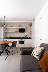 a living room with a couch and a table at Apt The V home in Puerto del Carmen +6 photos