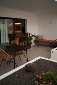 a living room with a table and chairs and a couch at Apt The V home in Puerto del Carmen