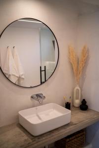a bathroom with a white sink and a mirror at Apt The V home in Puerto del Carmen