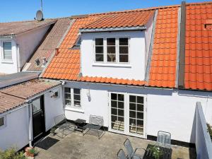 a white house with an orange roof at 5 person holiday home in Løkken in Løkken