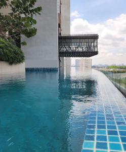 a swimming pool with a bridge over the water at Lumi Tropicana Unique Deals in Kota Damansara