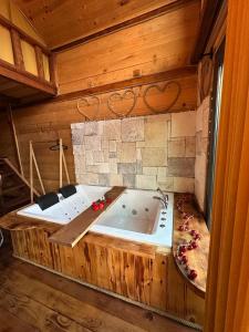 a large wooden bath tub in a room at The Reo's Suit in Çayırdüzü