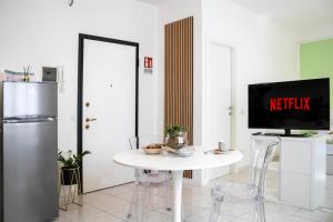 a kitchen with a white table with a tv on it at Casa Violante in Ancona