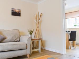 a living room with a couch and a table at Filey Central One - Uk31706 in Filey