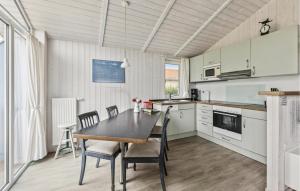 a kitchen with a dining room table and chairs at Friedrichskoog-Deichblick 4 in Friedrichskoog