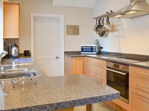 a kitchen with a sink and a counter top at Middleton House in Filey