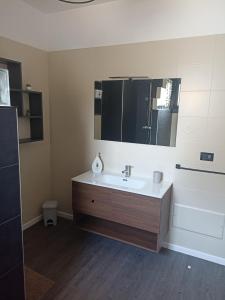 a bathroom with a sink and a mirror at Casa Soleluna Salento in Galatone