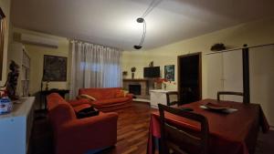 a living room with a table and chairs and a living room at Civico 51Appartamento a Sassuolo in Sassuolo