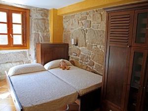 a bedroom with a bed with a teddy bear on it at Casa Noelmar in Combarro