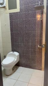 a bathroom with a toilet and a shower at منازل سمو in Buraydah +7 photos