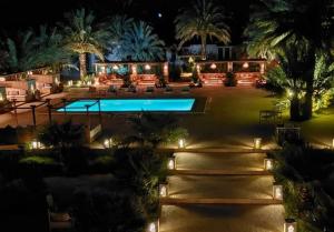 an aerial view of a house with a swimming pool at night at Riad safari camp in Merzouga