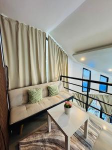 a living room with a couch and a table at Sunset Island View Villa El Nido in El Nido