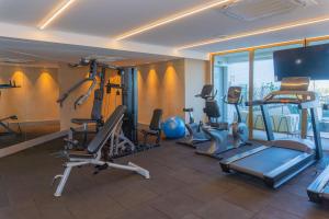 a gym with cardio equipment in a hotel room at Vista mar - Flat Parque do Cais 1211 in Recife
