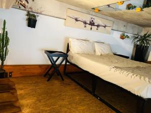 a bedroom with a bed and a table in a room at Lofty Hipster in Johannesburg