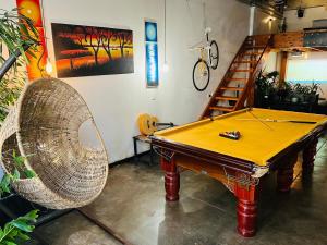 a ping pong table and a chair in a room at Lofty Hipster in Johannesburg