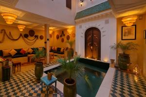 a living room with a swimming pool in a house at Riad Belikoss Pool & SPA in Marrakech