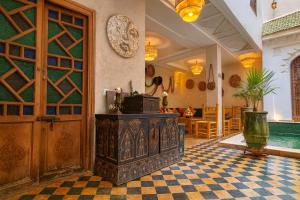 a room with a wooden door and a table at Riad Belikoss Pool & SPA in Marrakech +170 photos