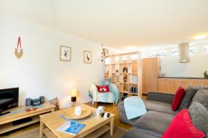 a living room with a couch and a table at Mountain Eden in Andermatt