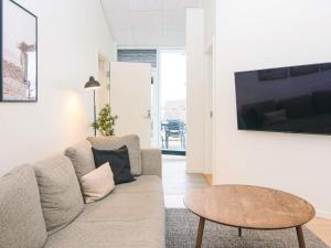 a living room with a couch and a table at 5 star holiday home in Ringkøbing in Ringkøbing