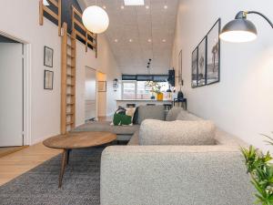 a living room with two couches and a table at 5 star holiday home in Ringkøbing in Ringkøbing