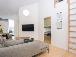 a living room with a couch and a tv at 5 star holiday home in Ringkøbing in Ringkøbing