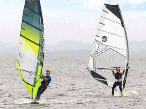 Deux personnes font de la planche à voile dans l'eau dans l'établissement 8 person holiday home in Ringkøbing-By Traum, à Ringkøbing 35 autres photos