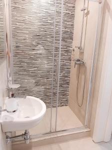 a bathroom with a sink and a shower at Seafront place Spinola StJulians in St. Julianʼs