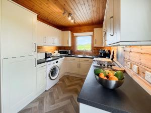 a kitchen with a bowl of fruit on a counter at Bengairn in Ringford